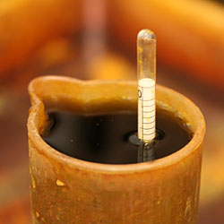 The density of the ferric chloride solution is checked by a hydrometer.