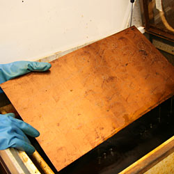 After 35 minutes, the copper plate is removed from the etching bath.