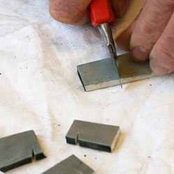 Cutting a piece of rubber.