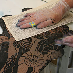 Catharina dries the plate carefully using paper from a telephone directory, which she has discovered is ideal for this purpose.