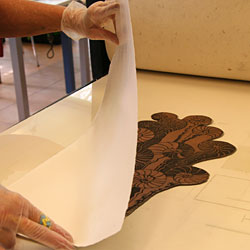 The paper is placed on the copper plate.