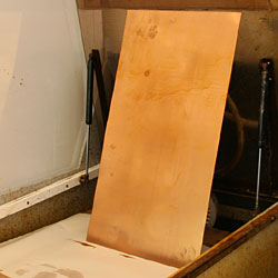 The plate is left to dry. Shellac is durable and will last through the entire etching process.